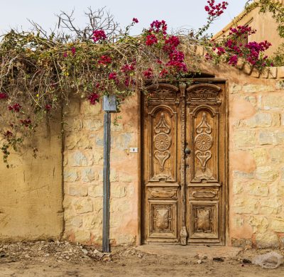 Faiyum, Egypt. Wooden door in a wall in the village of Faiyum.